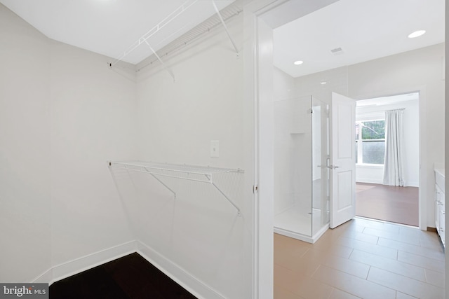 spacious closet featuring visible vents