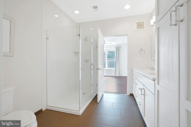 bathroom featuring vanity, visible vents, a stall shower, tile patterned flooring, and toilet