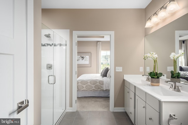 bathroom with tile patterned flooring, vanity, and a shower with shower door