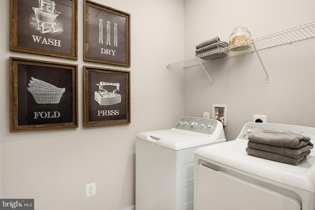 washroom featuring cabinets and independent washer and dryer