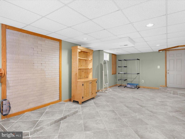 basement featuring a drop ceiling and tile patterned flooring