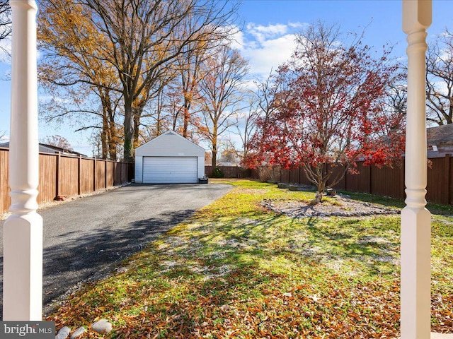 view of yard featuring an outbuilding and a garage