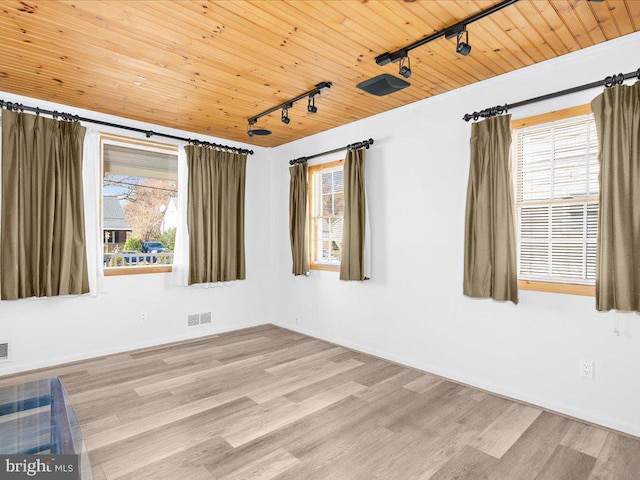 unfurnished room featuring light wood-type flooring, rail lighting, and wood ceiling