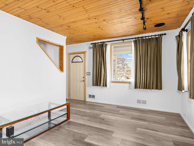 interior space with ornamental molding, light hardwood / wood-style flooring, and wooden ceiling