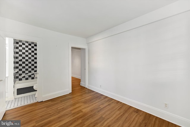 empty room with hardwood / wood-style flooring