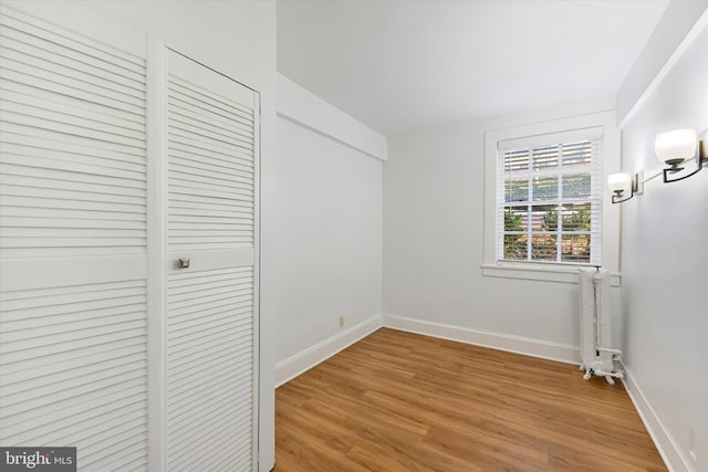 220 Stony Run Ln Unit Dg, Baltimore, MD 21210 - unfurnished bedroom with light wood-style flooring, radiator heating unit, and baseboards