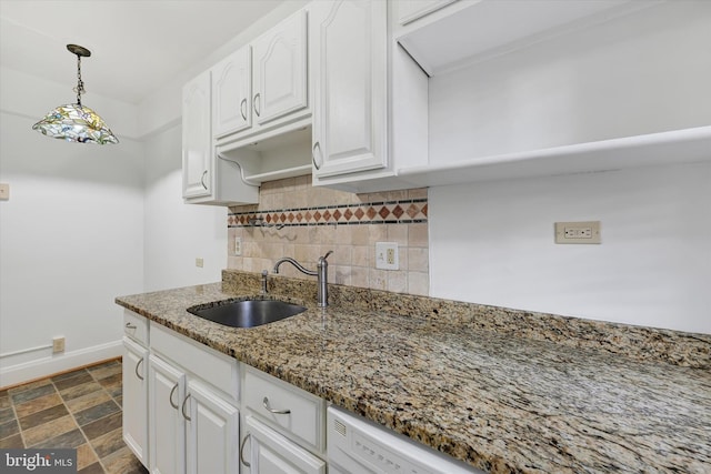 220 Stony Run Ln Unit Dg, Baltimore, MD 21210 - kitchen featuring a sink, tasteful backsplash, white cabinets, baseboards, and light stone counters