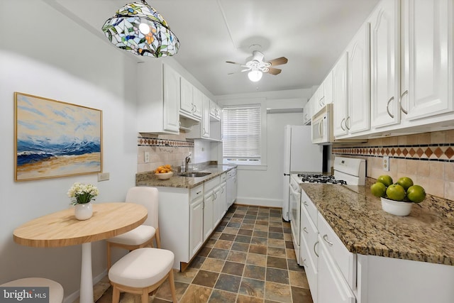 220 Stony Run Ln Unit Dg, Baltimore, MD 21210 - kitchen with white appliances, a sink, decorative backsplash, ceiling fan, and white cabinets