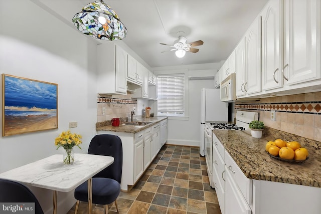 kitchen featuring decorative backsplash, white cabinetry, sink, and white appliances