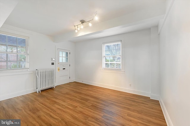 220 Stony Run Ln Unit Dg, Baltimore, MD 21210 - unfurnished room with radiator heating unit, wood finished floors, baseboards, and rail lighting