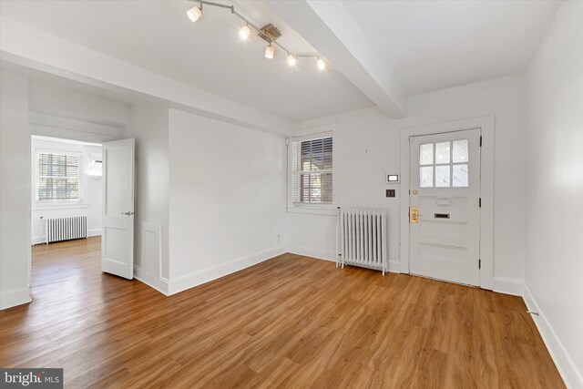 220 Stony Run Ln Unit Dg, Baltimore, MD 21210 - entryway with radiator, healthy amount of natural light, light wood-style flooring, and beam ceiling