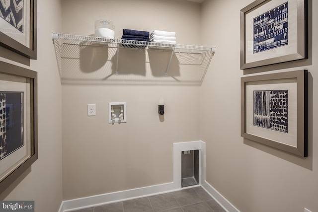 laundry room featuring washer hookup, hookup for an electric dryer, and dark tile patterned floors