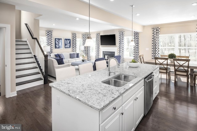 kitchen featuring a center island with sink, dark hardwood / wood-style floors, white cabinets, and sink