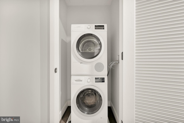 washroom featuring stacked washer and clothes dryer