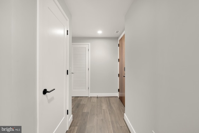 corridor with light wood-type flooring