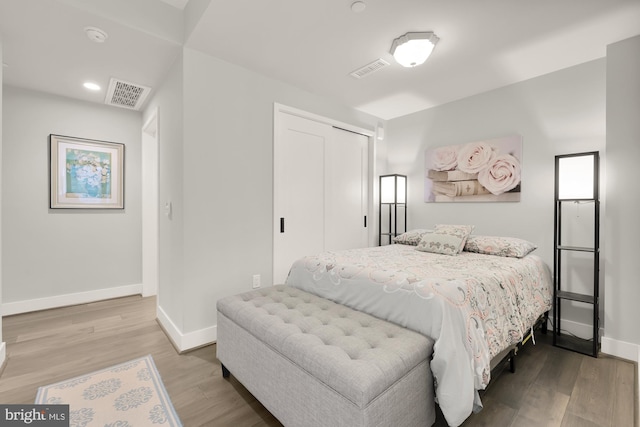 bedroom featuring a closet and hardwood / wood-style flooring