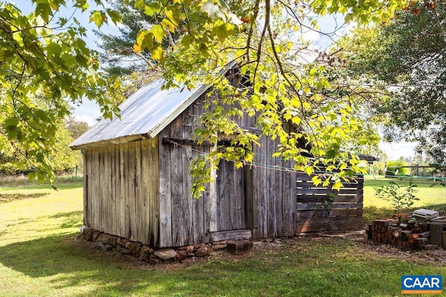 view of outbuilding with a yard