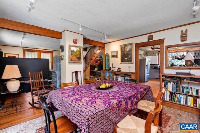 dining area featuring ceiling fan, light wood-type flooring, crown molding, and track lighting