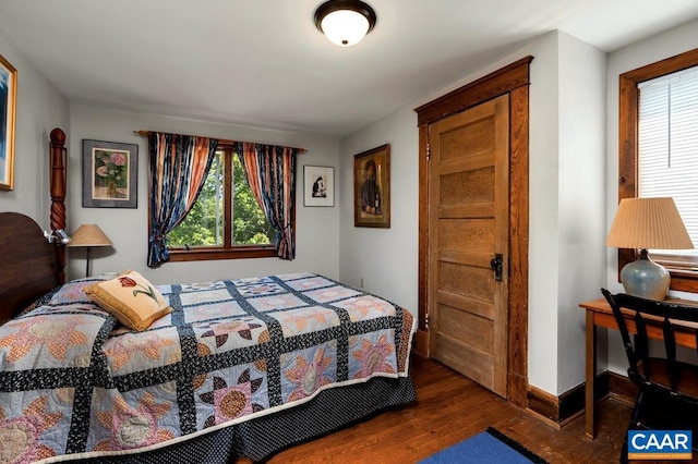 bedroom featuring dark hardwood / wood-style flooring and multiple windows