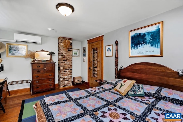 bedroom featuring a wall mounted air conditioner and dark hardwood / wood-style floors