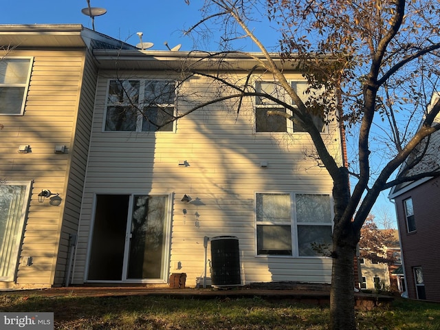 rear view of house featuring central AC unit