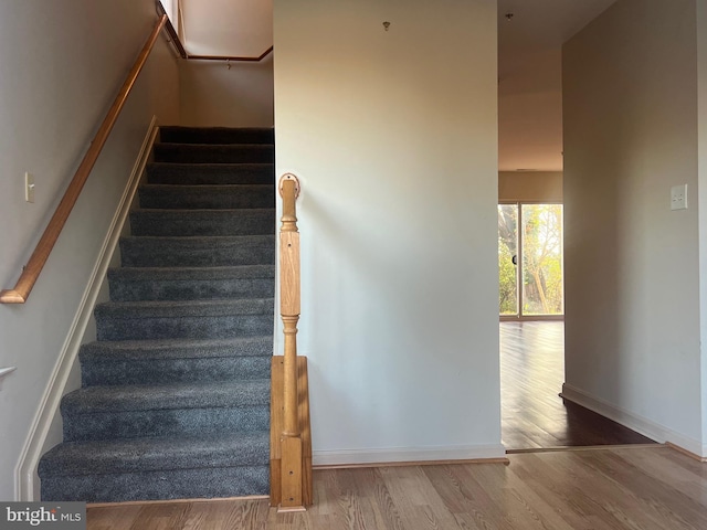 stairs featuring hardwood / wood-style flooring