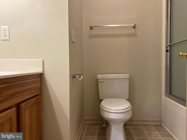 bathroom featuring shower / bath combination with glass door and toilet