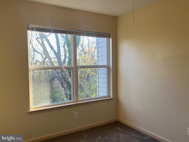 empty room featuring dark carpet