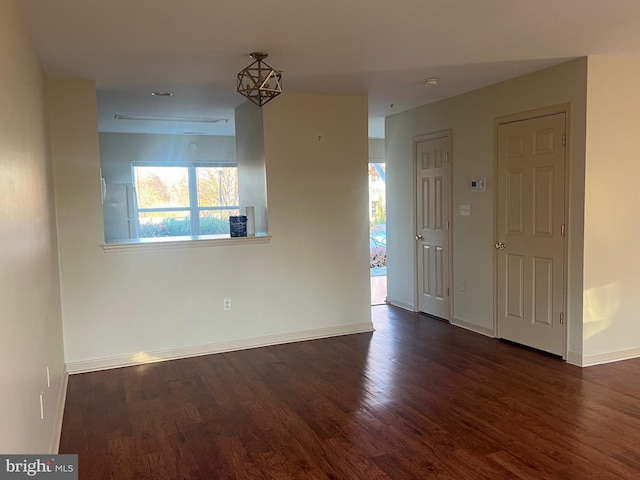 empty room featuring dark hardwood / wood-style flooring