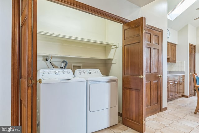 laundry area with light tile patterned floors and separate washer and dryer