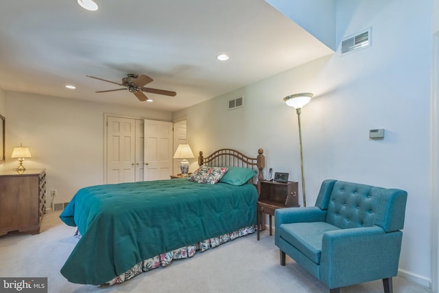 carpeted bedroom featuring ceiling fan and a closet