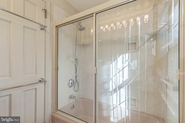 bathroom with shower / bath combination with glass door