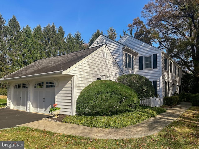 view of side of home featuring a garage