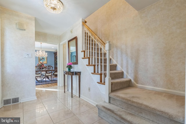 staircase featuring a notable chandelier