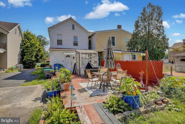 rear view of property with a wooden deck