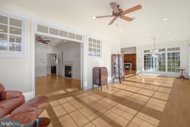 living room with ceiling fan and hardwood / wood-style flooring