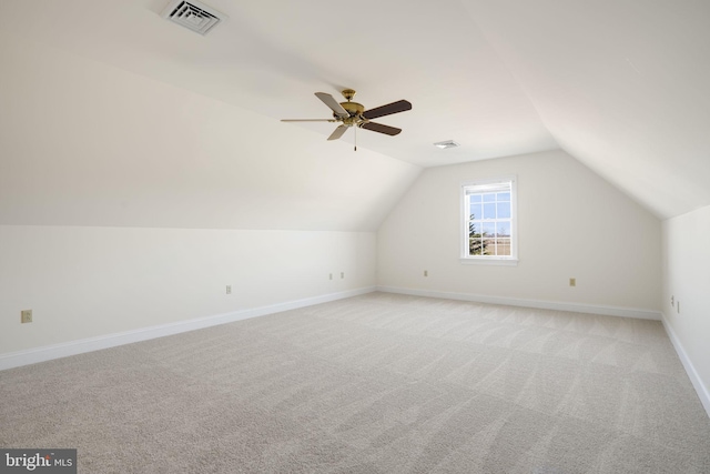 additional living space featuring ceiling fan, light carpet, and vaulted ceiling