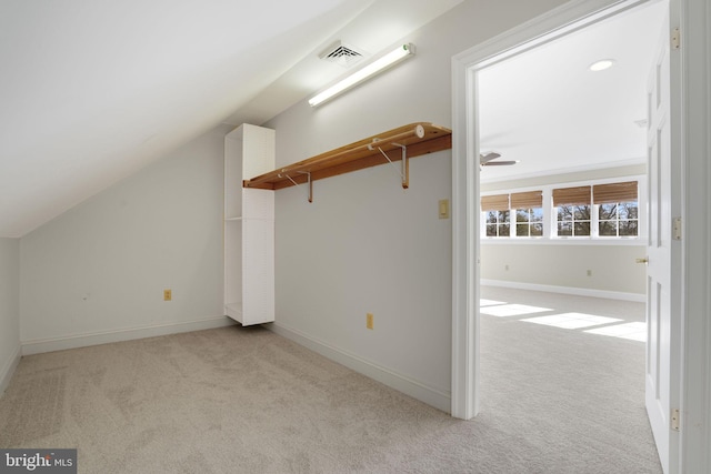 additional living space with ceiling fan, light colored carpet, and lofted ceiling