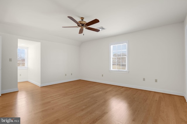 unfurnished room with light hardwood / wood-style floors, ceiling fan, and a healthy amount of sunlight