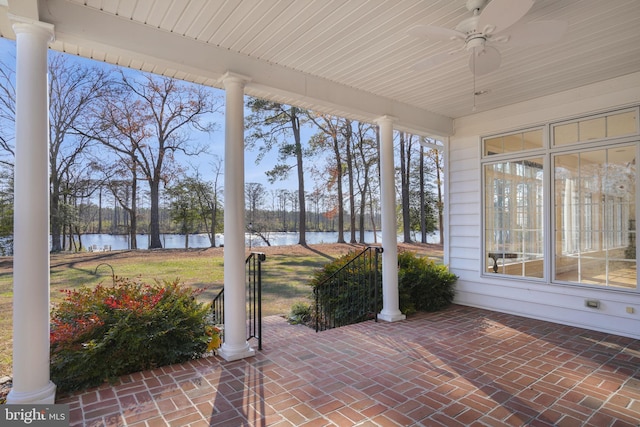 view of patio / terrace featuring ceiling fan and a water view