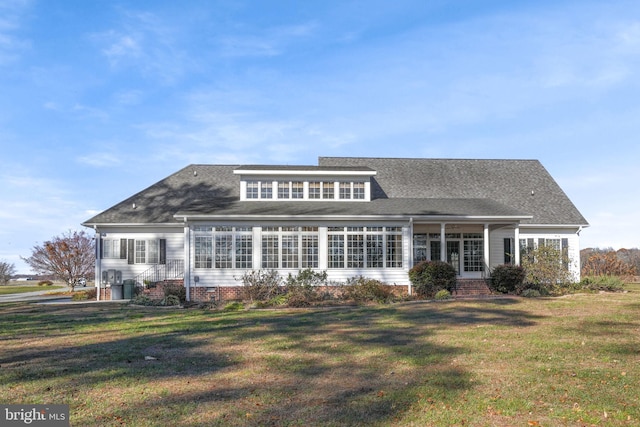 rear view of house with a lawn