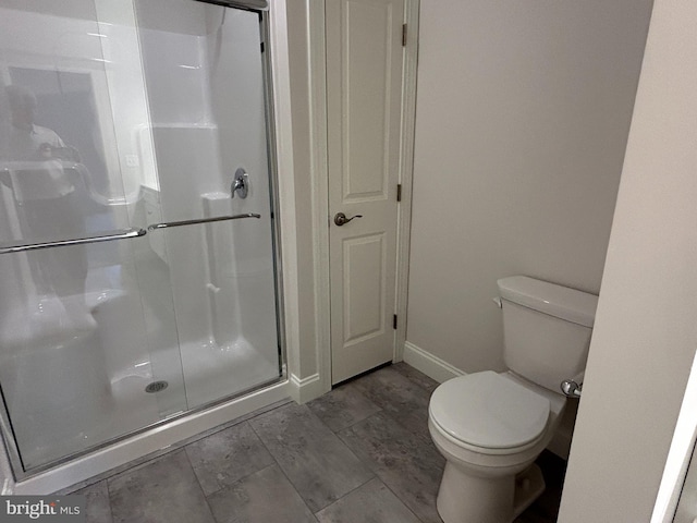 bathroom with toilet and walk in shower