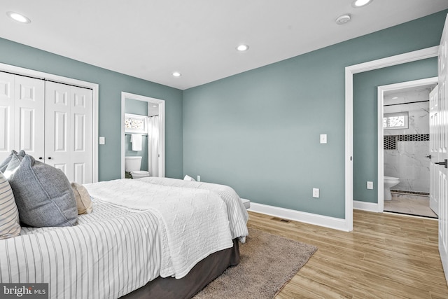 bedroom featuring connected bathroom, light hardwood / wood-style floors, and a closet