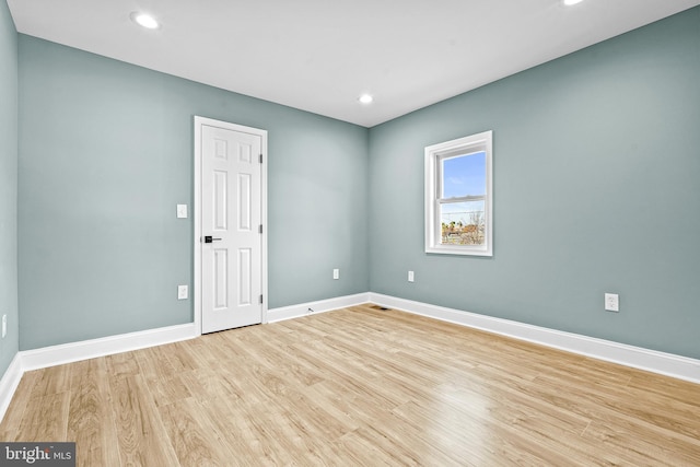 spare room with light hardwood / wood-style floors