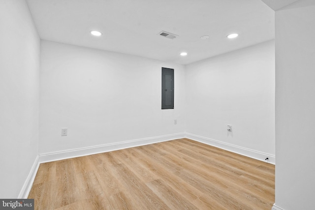 spare room with light wood-type flooring and electric panel