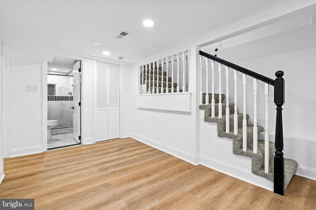 staircase featuring wood-type flooring