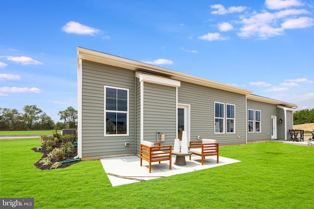 back of property featuring a lawn and a patio