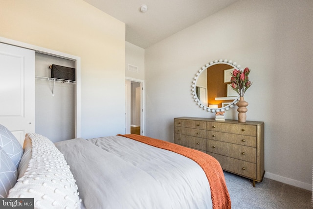 carpeted bedroom featuring vaulted ceiling and a closet