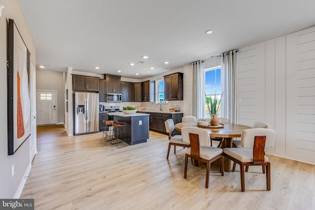 dining area with light hardwood / wood-style flooring and sink