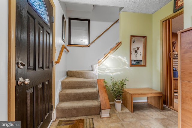 entryway featuring a textured ceiling